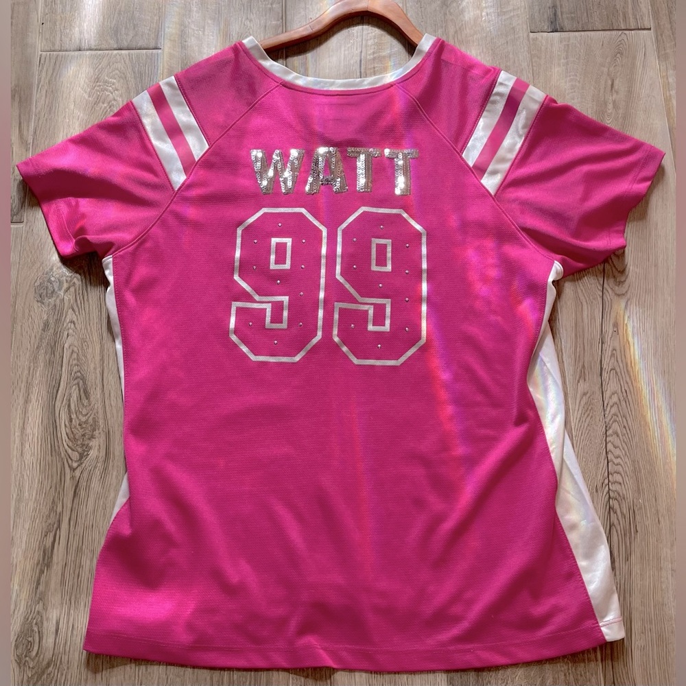 A pink jersey of watt number 99 on the Texans football team